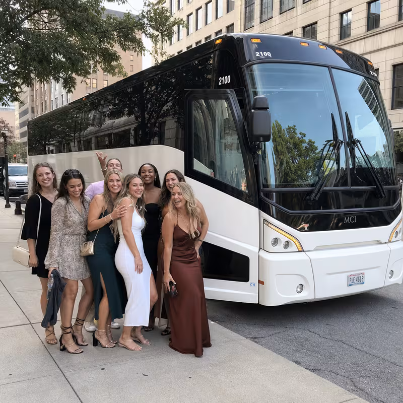 Passengers loading luggage while boarding an Cincinnati group shuttle