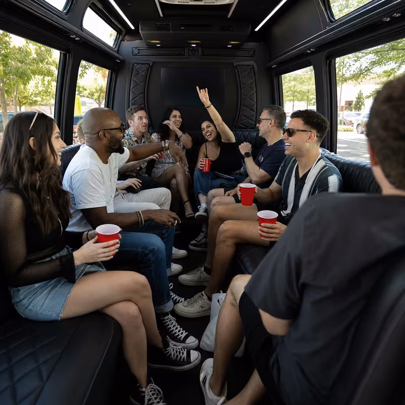 Group boarding a white charter bus for Concert Transportation transportation in Cincinnati