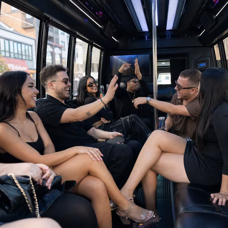 Passengers loading luggage while boarding an Cincinnati group shuttle