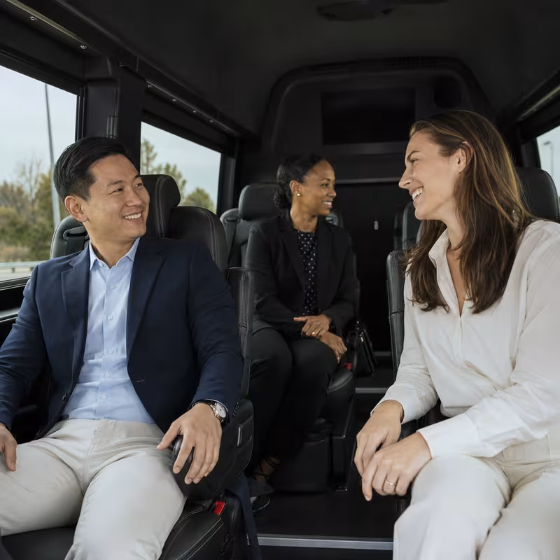 Group boarding a white charter bus for Corporate Transportation transportation in Cincinnati