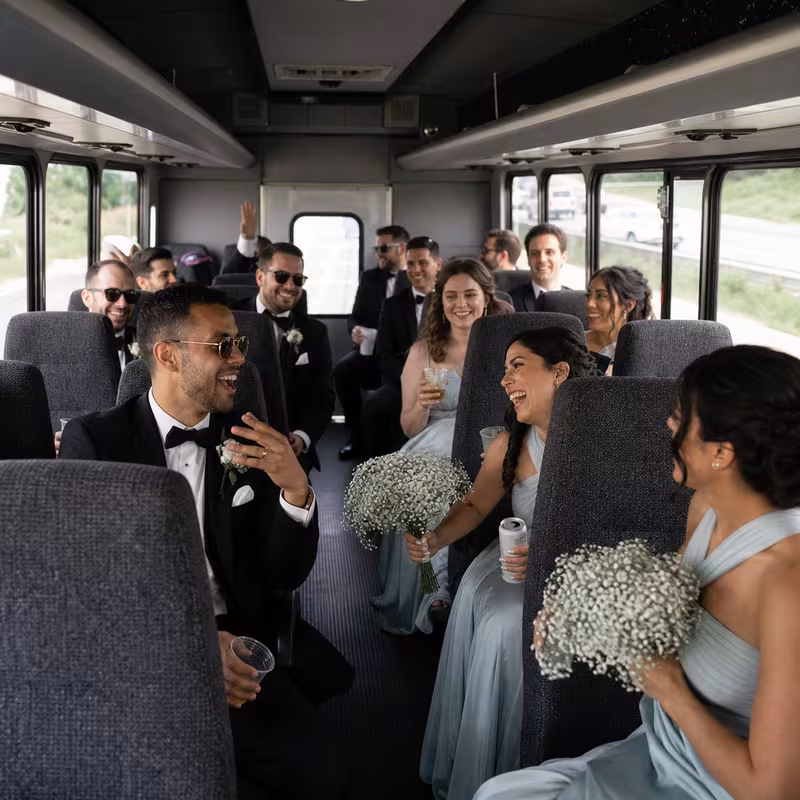 Group boarding a white charter bus for Wedding Transportation transportation in Cincinnati