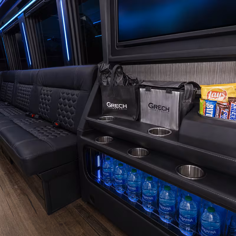 Party bus interior with wraparound leather seating and LED lighting in Cincinnati